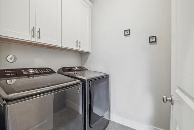 laundry room with cabinet space, independent washer and dryer, and baseboards