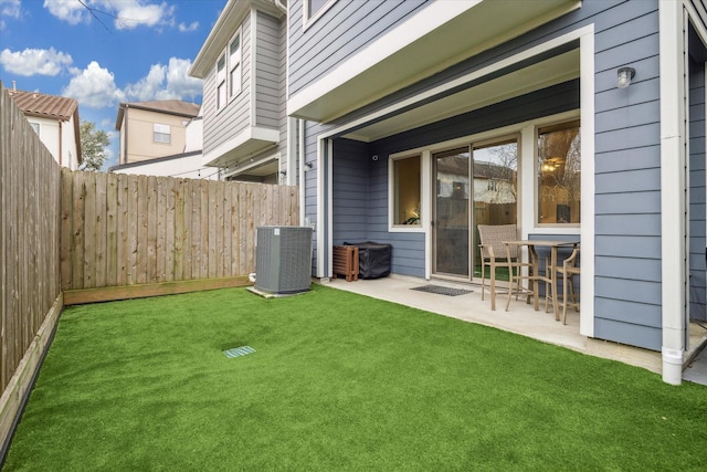 view of yard featuring cooling unit, a fenced backyard, and a patio area