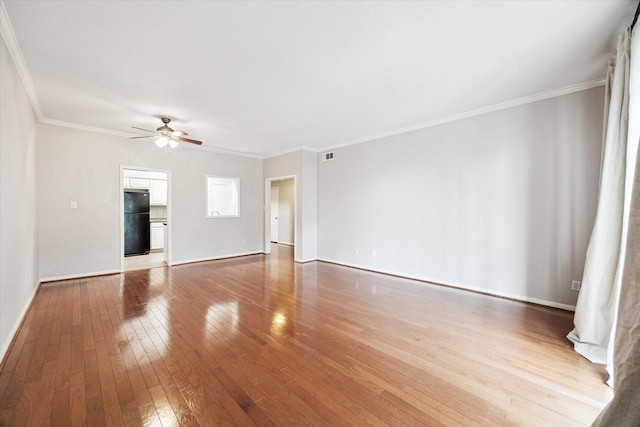 unfurnished living room with visible vents, baseboards, ceiling fan, ornamental molding, and hardwood / wood-style flooring