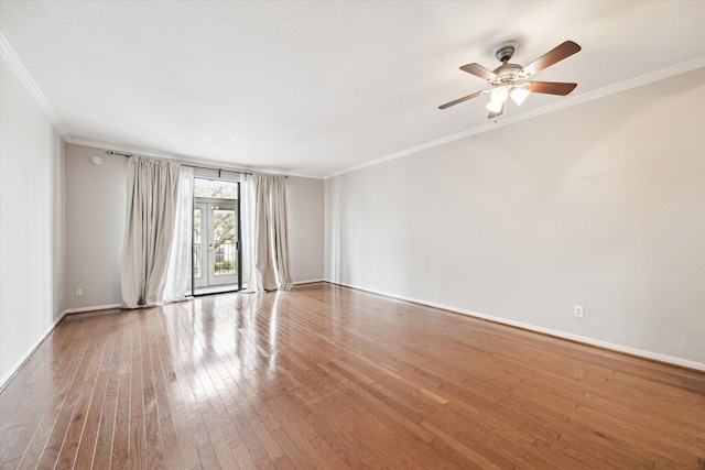 unfurnished room with baseboards, wood-type flooring, ceiling fan, and crown molding