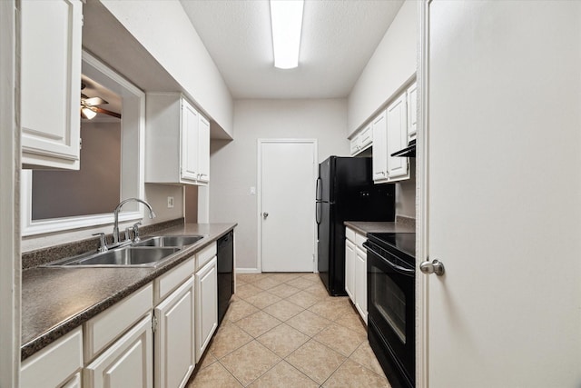 kitchen featuring light tile patterned floors, a sink, black appliances, under cabinet range hood, and dark countertops