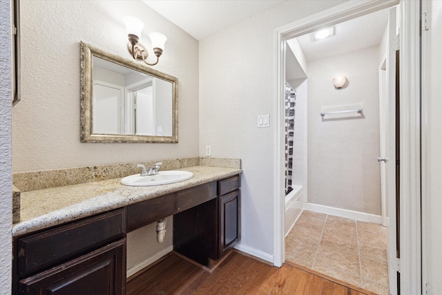 full bath featuring shower / bathtub combination with curtain, baseboards, wood finished floors, and vanity