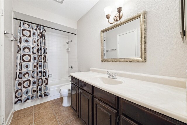 full bath featuring tile patterned floors, shower / bath combo with shower curtain, toilet, and vanity