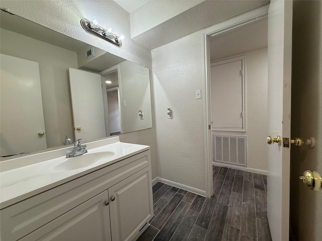 bathroom with visible vents, baseboards, and wood tiled floor