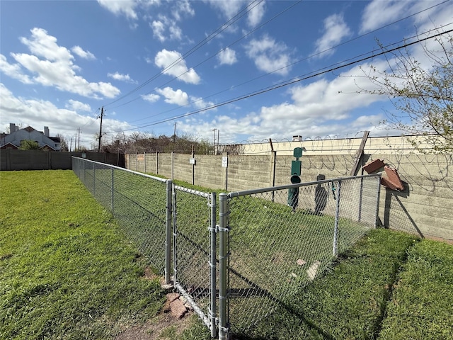 view of yard featuring fence and a gate