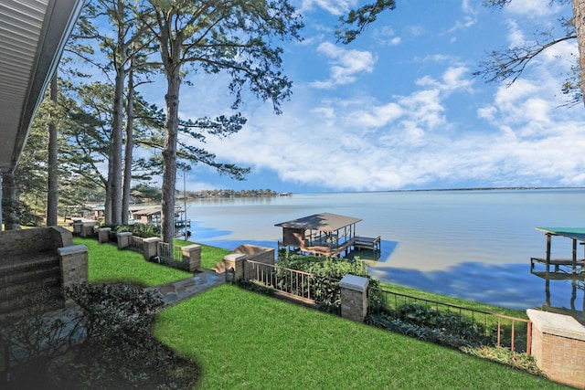 exterior space with a yard, a water view, and boat lift