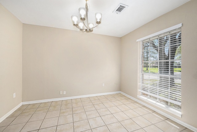 empty room with visible vents, baseboards, an inviting chandelier, and light tile patterned flooring