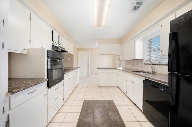 kitchen featuring visible vents, light tile patterned flooring, a sink, black appliances, and tasteful backsplash