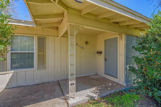 entrance to property featuring brick siding