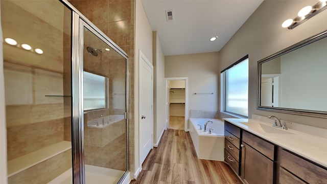 full bath with visible vents, a stall shower, and a garden tub