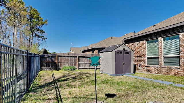 view of yard with a storage unit, a fenced backyard, and an outdoor structure