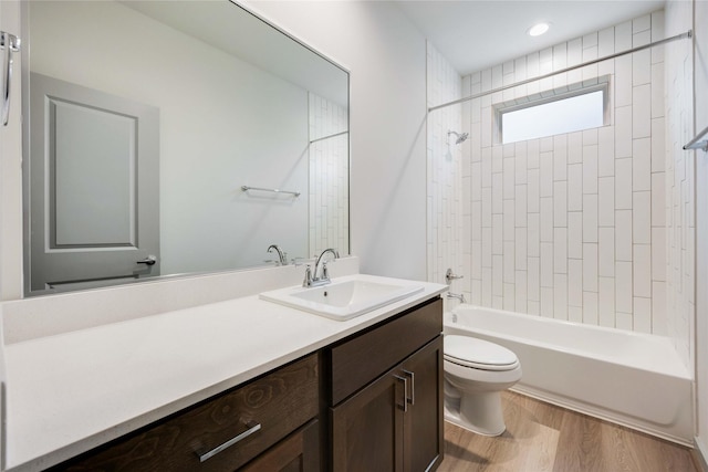 full bathroom with shower / bathing tub combination, toilet, wood finished floors, and vanity