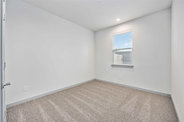 carpeted spare room with recessed lighting and baseboards