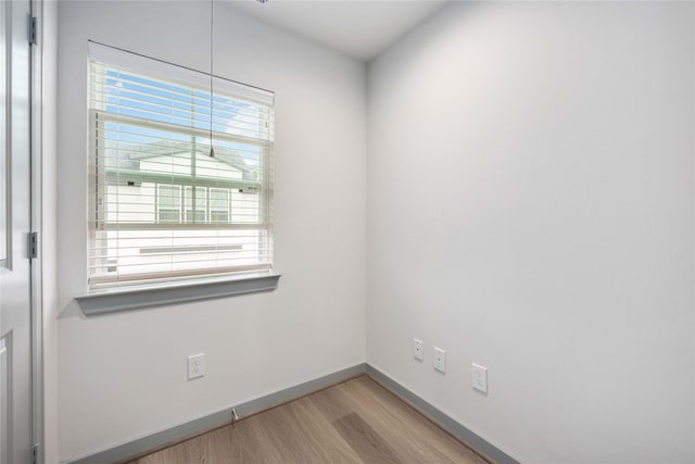 empty room featuring baseboards and wood finished floors