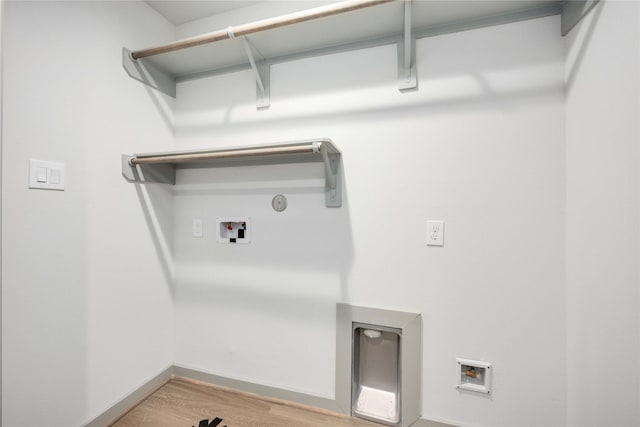 laundry room featuring baseboards, light wood-type flooring, gas dryer hookup, washer hookup, and laundry area