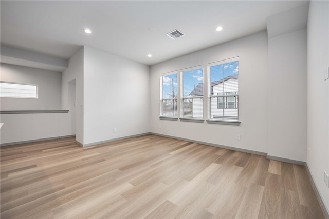 unfurnished room with recessed lighting, baseboards, visible vents, and light wood-type flooring