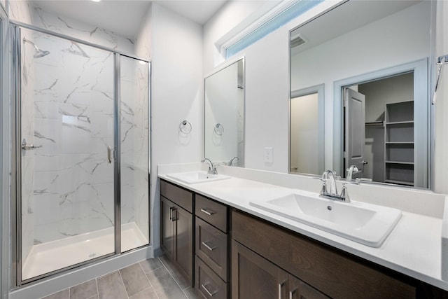 bathroom with visible vents, a marble finish shower, and a sink