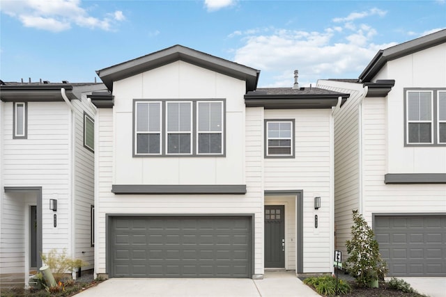 townhome / multi-family property featuring a garage and concrete driveway