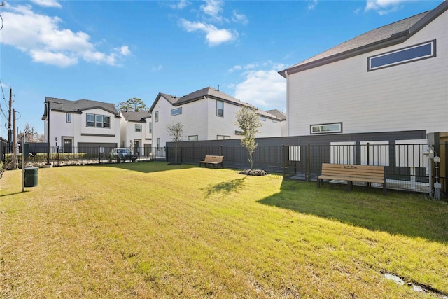 view of yard featuring fence and a residential view