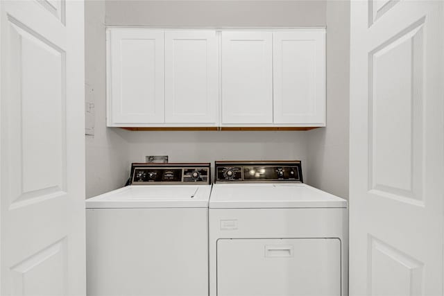 laundry room with cabinet space and washing machine and clothes dryer