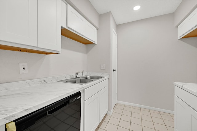 kitchen featuring baseboards, recessed lighting, a sink, white cabinets, and black dishwasher