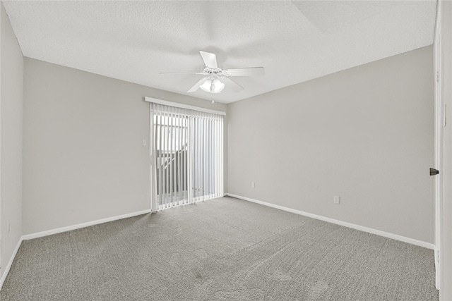 spare room featuring carpet flooring, a textured ceiling, baseboards, and ceiling fan