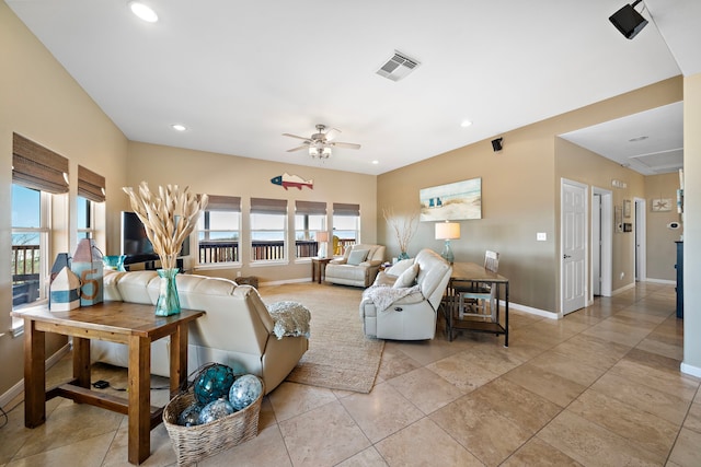 living room with a wealth of natural light, visible vents, ceiling fan, and recessed lighting