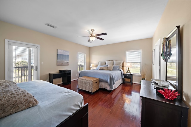 bedroom with access to exterior, visible vents, dark wood finished floors, and multiple windows