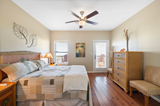 bedroom with multiple windows, hardwood / wood-style floors, and a ceiling fan