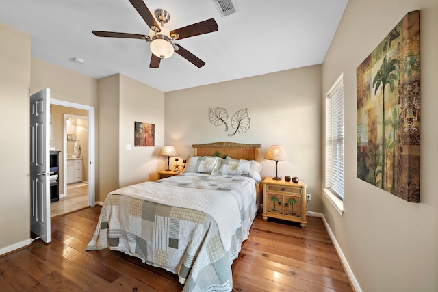 bedroom featuring visible vents, baseboards, ceiling fan, and hardwood / wood-style flooring