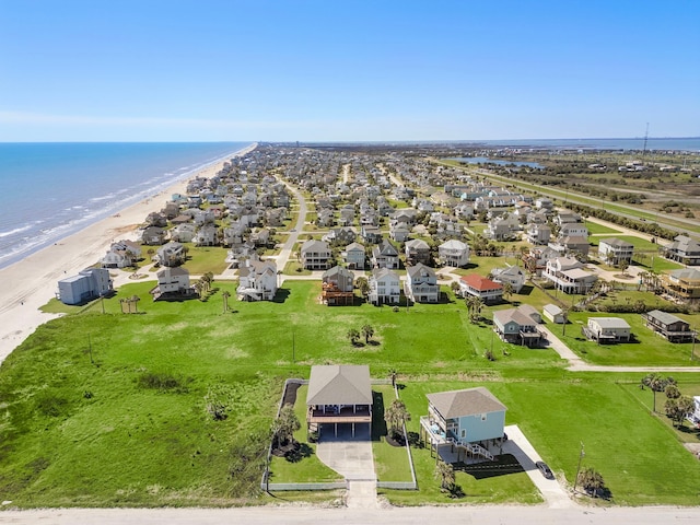 drone / aerial view with a residential view, a beach view, and a water view