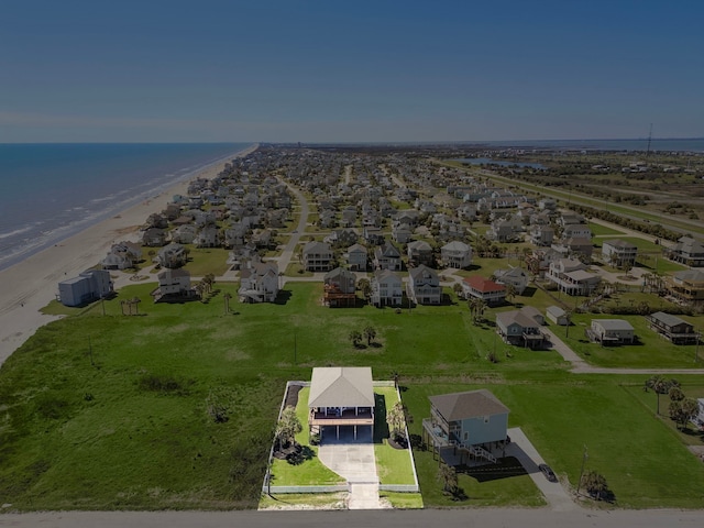 birds eye view of property with a view of the beach, a residential view, and a water view