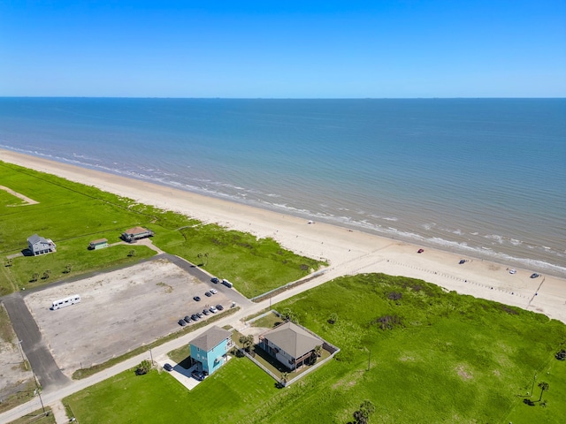 drone / aerial view featuring a water view and a view of the beach