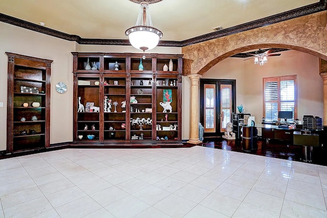 interior space with arched walkways, tile patterned flooring, crown molding, and visible vents