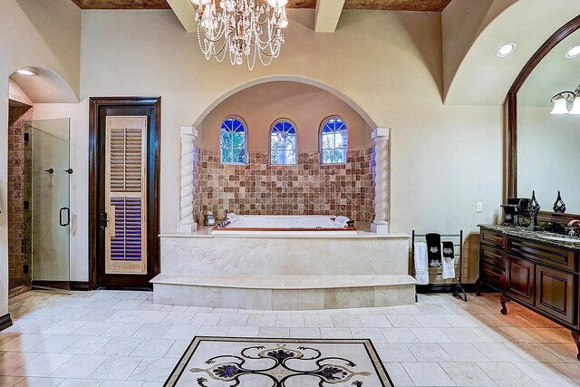 full bath with vanity, a garden tub, a notable chandelier, and a stall shower