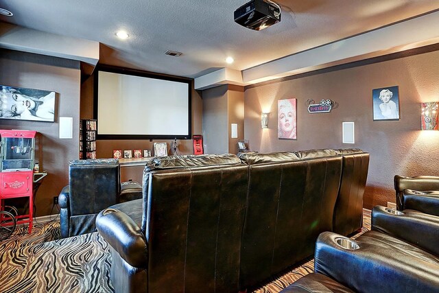 home theater with a textured ceiling and a textured wall