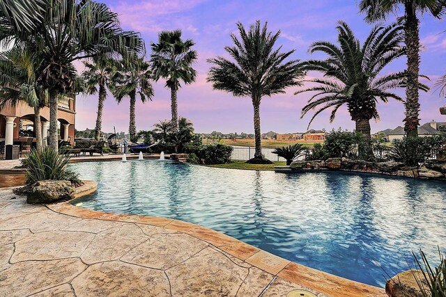 community pool featuring a patio area and a water view