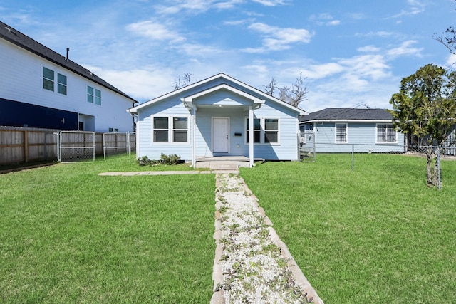 view of front facade with a front yard and fence