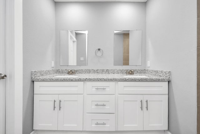 full bath featuring double vanity and a sink