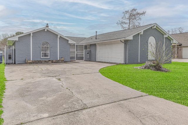 ranch-style home with a front yard, a garage, brick siding, and driveway