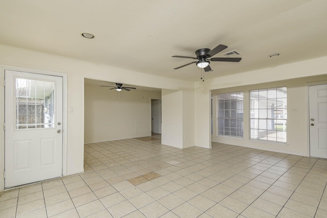 entrance foyer featuring light tile patterned floors, visible vents, and a healthy amount of sunlight