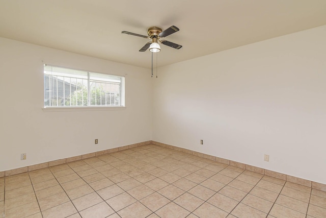 unfurnished room featuring baseboards and ceiling fan