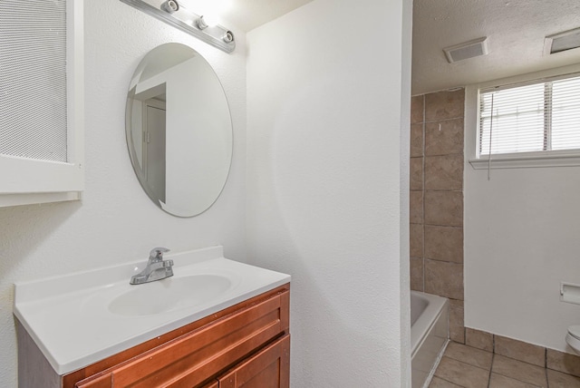 full bath with tile patterned floors, visible vents, toilet, a textured ceiling, and vanity