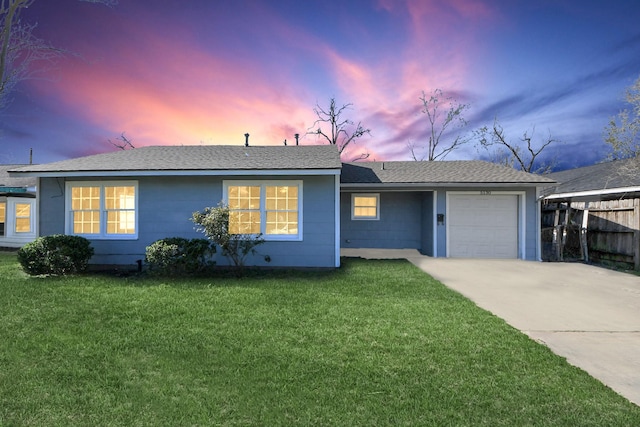 single story home featuring fence, driveway, roof with shingles, a garage, and a lawn