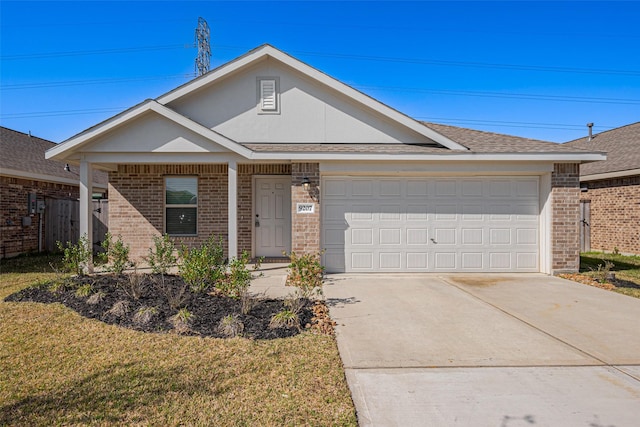 ranch-style house with brick siding, a shingled roof, a front lawn, a garage, and driveway