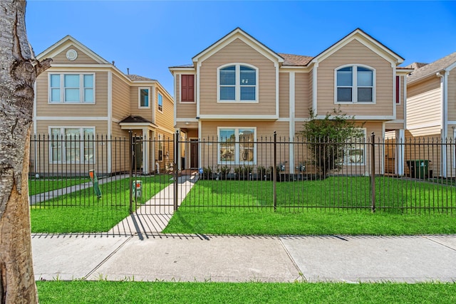 multi unit property featuring a fenced front yard and a front yard