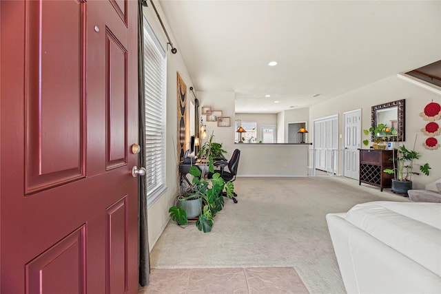 foyer with light carpet and recessed lighting