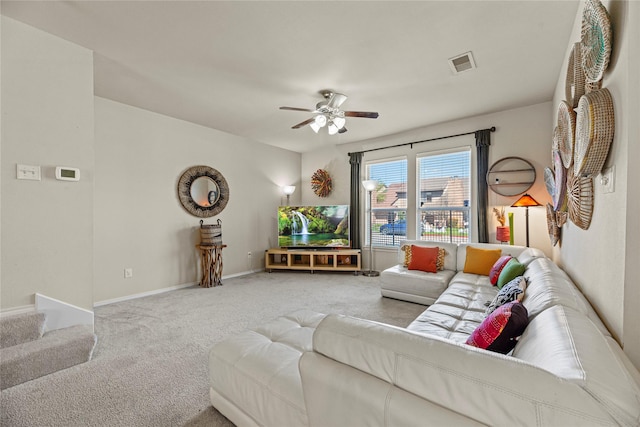 living area with visible vents, carpet flooring, baseboards, and a ceiling fan