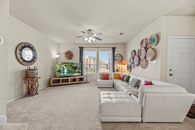 living area featuring visible vents, carpet flooring, baseboards, and ceiling fan