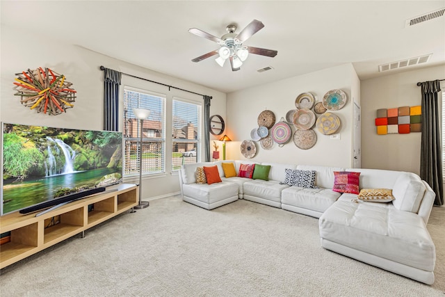 living area with visible vents, carpet floors, and ceiling fan